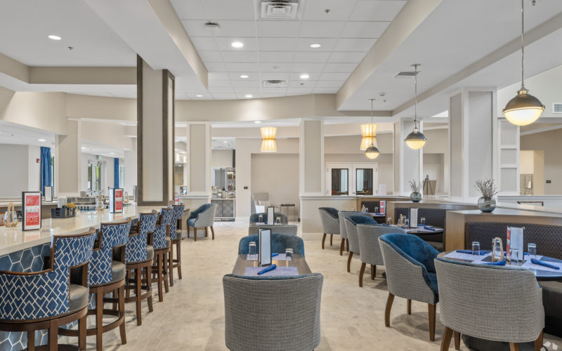 Modern dining area at Aviva Port St. Lucie featuring stylish seating, ambient lighting, and a spacious bar area.